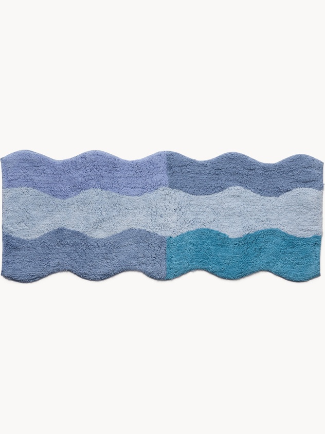 Tufted cotton bath mat with wavy edge