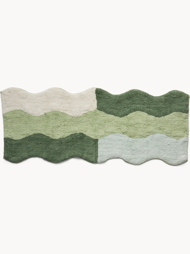 Tufted cotton bath mat with wavy edge